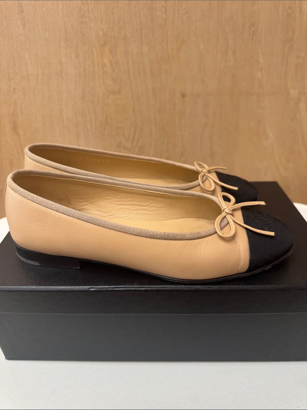 CHANEL Beige Leather Ballet Flats with Black Cap Toe and Bow